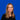 Bild zeigt Kirsten Gröbel vor blauem Hintergrund, lächelnd in die Kamera